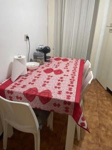 a table with a red table cloth with roses on it at Sogni al Duomo in Catania