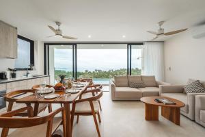 a kitchen and living room with a table and chairs at Staylar Sunrise Villas - Chaweng Noi, Koh Samui in Amphoe Koh Samui