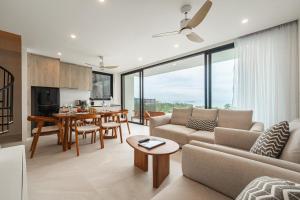 a living room with a couch and a table at Staylar Sunrise Villas - Chaweng Noi, Koh Samui in Amphoe Koh Samui