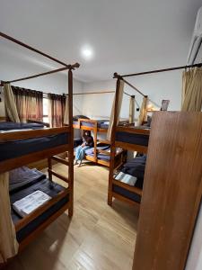 a room with four bunk beds in a room at Kali Code Home in Yogyakarta
