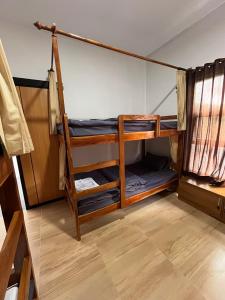 a room with three bunk beds in a room at Kali Code Home in Yogyakarta