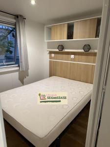 a bed in a small room with a white mattress at L'Escapade Seignossaise in Seignosse +32 photos