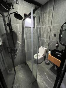 a bathroom with a shower with a toilet and a sink at Kali Code Home in Yogyakarta +44 photos