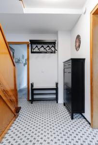 a kitchen with a black cabinet and a tile floor at Ferienwohnung Alte Scheune in Westerburg