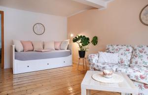 a living room with a bed and a couch at Ferienwohnung Alte Scheune in Westerburg +10 photos