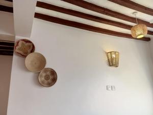 a group of hats hanging on a wall at AMOODY MANZIl in Shela