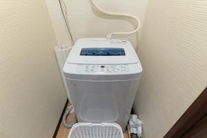 a toilet in a corner of a room at 蛮子民宿 金閣寺 in Kyoto