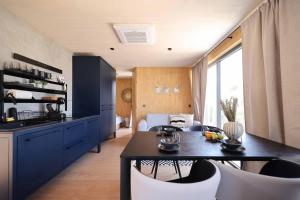 a kitchen with a table and chairs in a room at Jazine BeachVilla5 in Tisno
