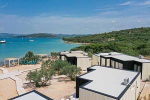 an aerial view of a house with a view of the water at Jazine BeachVilla5 in Tisno