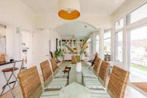 a dining room with a glass table and chairs at Escape To your Private Pool, Sea Views and Bbq in Jinámar