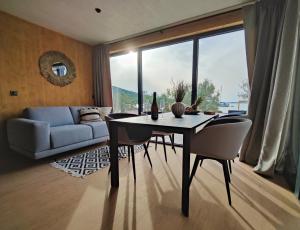 a living room with a table and chairs and a couch at Jazine BeachVilla5 in Tisno