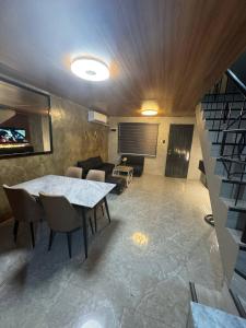 a living room with a table and a couch at Casa Maria Guest House in Angeles