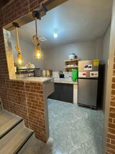 a kitchen with a counter and a refrigerator at Casa Maria Guest House in Angeles