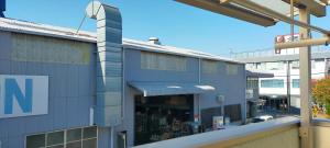 a building with a sign on the side of it at ペット可 Clear Up Guest House in Takatuki