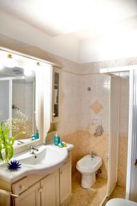 a bathroom with a sink and a toilet at Casa Francesco Seaside in Sant'Angelo D'Ischia