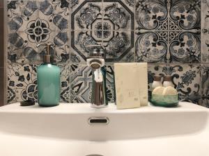 a bathroom sink with two bottles and a book at Casa Serena in Odorheiu Secuiesc
