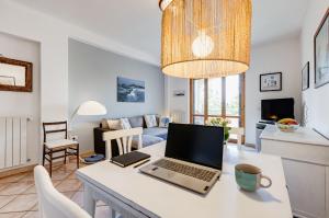 a kitchen and living room with a laptop on a table at Appartamento vista mare, 100mt dall'Ospedale Pediatrico, a 200mt dal mare, 1h da Roma Termini in Santa Marinella
