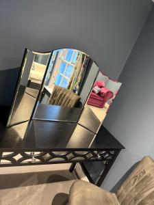 a mirror sitting on top of a table at The Ship Inn's Mill Cottage - Weavers Way in Gatehouse of Fleet