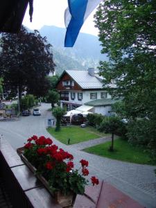 einen Blick vom Balkon eines Hauses mit roten Blumen in der Unterkunft Hotel garni Königslinde - Wandern, Radeln, Skifahren & Genießen in Bayrischzell
