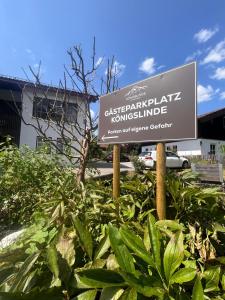 a sign in the bushes in front of a building at Hotel garni Königslinde - Wandern, Radeln, Skifahren & Genießen in Bayrischzell +94 photos