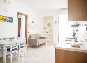 a kitchen and living room with a couch and a table at Casa Francesco Seaside in Sant'Angelo D'Ischia +6 photos
