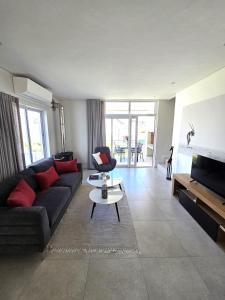 a living room with a couch and a table at Casa Voliere in Stellenbosch