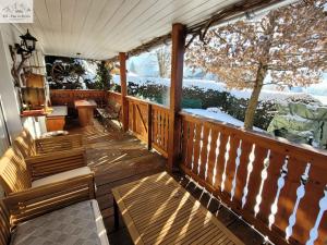 a porch with chairs and a table and a tree at Haus André in Bad Mitterndorf
