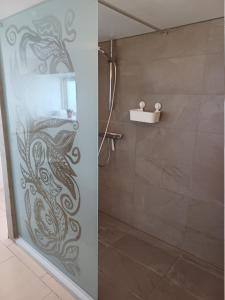 a shower with a glass door with a fish painted on it at Kjærgaarden B&B - Bed & Breakfast i Havnsø in Føllenslev +35 photos