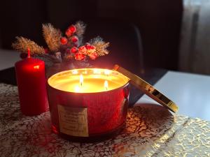 a candle and a knife on a table with a christmas centerpiece at Baltic sea view in Liepāja +22 photos
