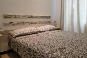 a bedroom with a bed with a pillow on it at lecasedimarco2 in La Spezia