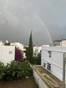 a rainbow in the sky over a city at honey moon zeinbe 3 in Hammamet