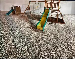 two childrens play equipment in a room with a slide at vacation apartment BANI PERAVIA in Boca Canasta