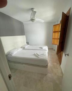 a small bedroom with two beds in a room at Apartamentos Silleria - A 4 min de la Catedral de Granada in Granada