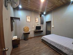 a bedroom with a bed and a sink and a television at Lightning House 2 in Da Lat