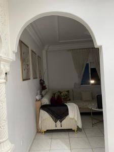 a living room with a bed and a couch at honey moon zeinbe 3 in Hammamet