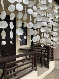 a bunch of glass spheres hanging from a wall at Cabugao Bed & Breakfast and Dorm in El Nido