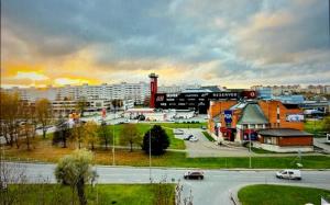 a city with a parking lot with cars and a building at Narva Kangelaste 2 Apartments in Narva