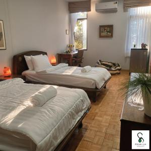 Postel nebo postele na pokoji v ubytování PhuKasa Valley Maesot