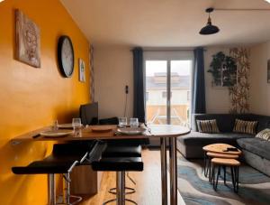 a living room with a table and a couch at Spacieux T5 confort 9 pers in Angers