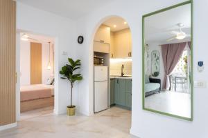 a room with a mirror and a kitchen and a bedroom at New! Sea View Apartment with Aircon in Center of Las Americas in Playa de las Americas +31 photos