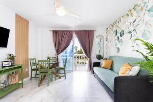 a living room with a couch and a table at New! Sea View Apartment with Aircon in Center of Las Americas in Playa de las Americas