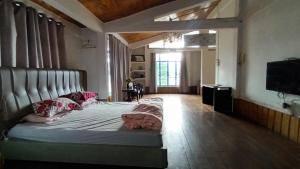 a bedroom with a large bed with at Dzükou Guest House in Kohīma