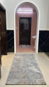 a bathroom with a rug in front of a door at شقة غرفتين وصالة 5 in Al Baha +1 photo