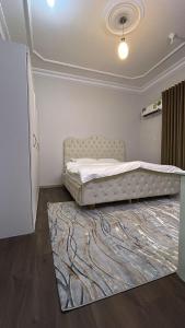 a bedroom with a bed with a rug on the floor at شقة غرفتين وصالة 5 in Al Baha