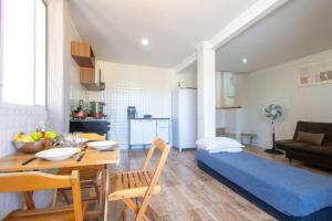 une cuisine et un salon avec une table et un canapé dans l'établissement Pousada Vila Merced, à Búzios