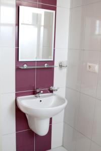 a bathroom with a sink and a mirror at Fethiye Pension in Fethiye