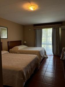 Ένα ή περισσότερα κρεβάτια σε δωμάτιο στο Los Naranjos Termal