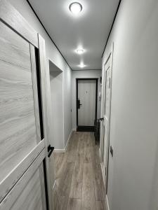 an empty hallway with a door and a hallway at Сатпаева, Телецентр in Taraz