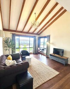 a living room with a couch and a tv at Comfortable 2BR Home in Hallam in Hallam