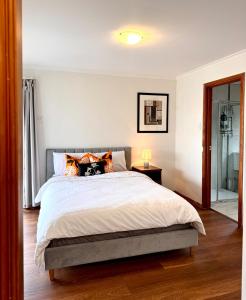 a bedroom with a large bed and a window at Comfortable 2BR Home in Hallam in Hallam